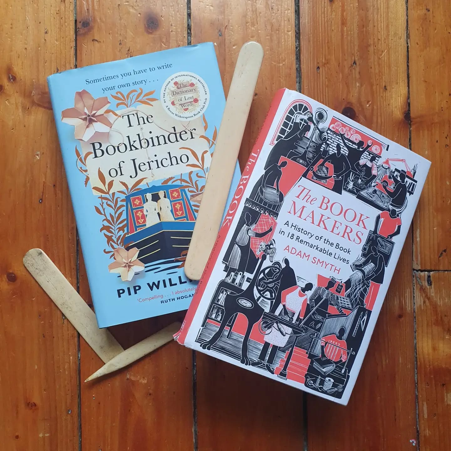 An easy one to pick for my bookbinder Sunday shelfie today as post bookshelf reorganisation these two ended up together.

The fiction: The Bookbinder of Jericho by Pip Williams. I'll be honest, when I first bought this I hadn't seen the cover or knew much of Oxford so was expecting a very different book 😆 However, this was a great read for me, with lots of interesting detail about a period of history I am interested in so I'm very glad I bought it.

The non-fiction: The Book Makers by Adam Smyth. A collection of biographies of people in various parts of the book trades. Starting with a name I dropped a lot during Heritage open Days - Wynkyn de Worde. Not had a chance to read it yet but can't wait.

[Image description: two books posed with bonefolders]