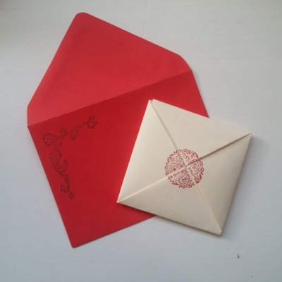 A folded letter paper and red envelope.