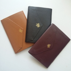 Three Notebooks with a gold tooled city on.