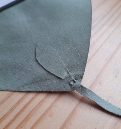 A close-up of the shaped tab that holds the tie in place