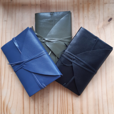 Three leather notebooks with ties