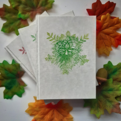 An image of three books with green man image on the cover