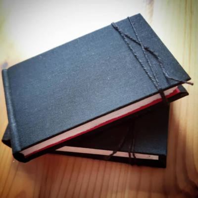 Two black sketchbooks