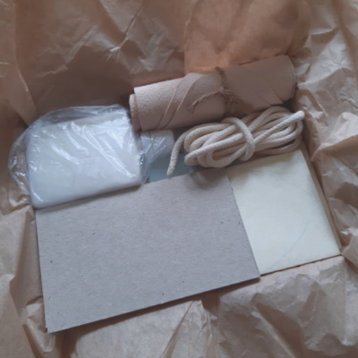A box packed with bookbinding materials includind leather
