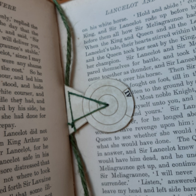 A bookmark with a revolving disc showing roman numerals