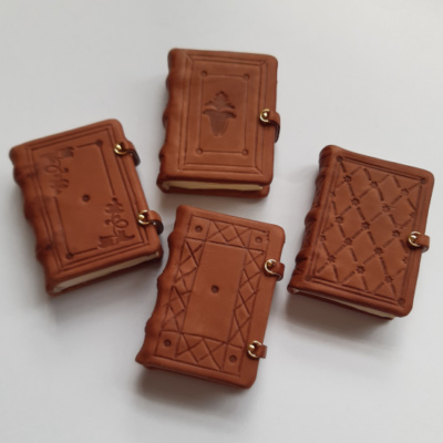 Four miniature blind tooled medieval style books