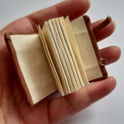 a miniature medieval style book showing the blank pages