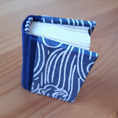 miniature book in blue and white wave pattern