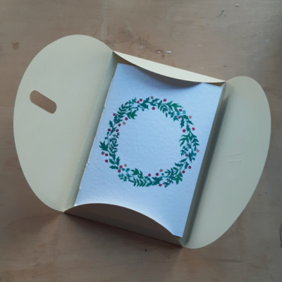 A pamphlet with a wreath on in an envelope
