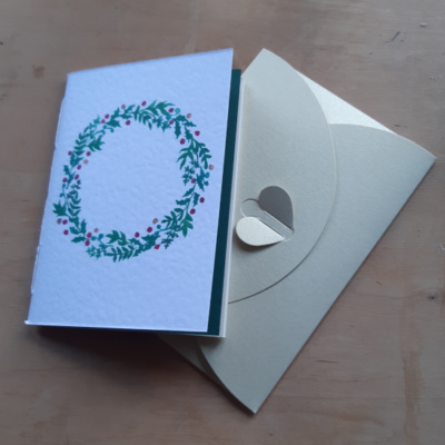 A pamphlet with a wreath on and an envelope