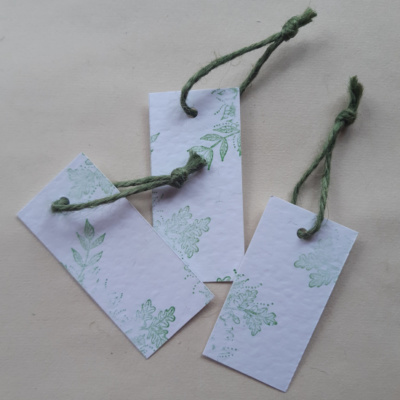 3 gift tags of white hammered card with foliage detail stamped on and finished with a green just twine