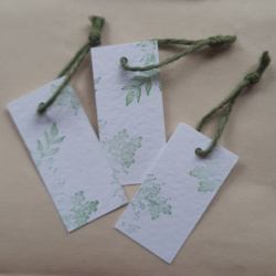 3 gift tags of white hammered card with foliage detail stamped on and finished with a green just twine
