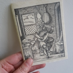 a pamphlet with a woodcut image of a luthier on it