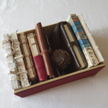 A wine red box containing multiple historical book models.